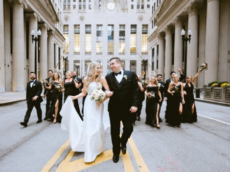 Bride and groom in street with wedding party