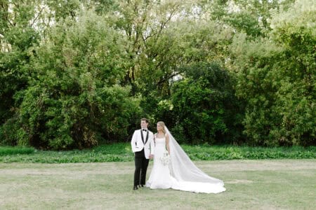 Bride and groom in green field